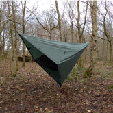 DD Hammocks 3x3 Pro tarp set up in a wooded area, showcasing versatile shelter options for outdoor adventures.